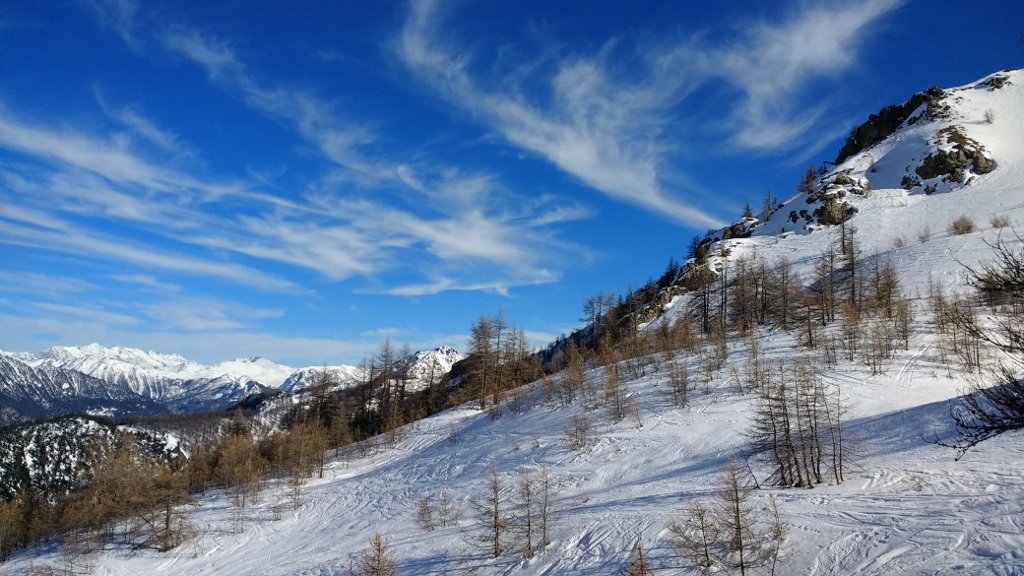 blue sky, fluffy clouds, and soft snow